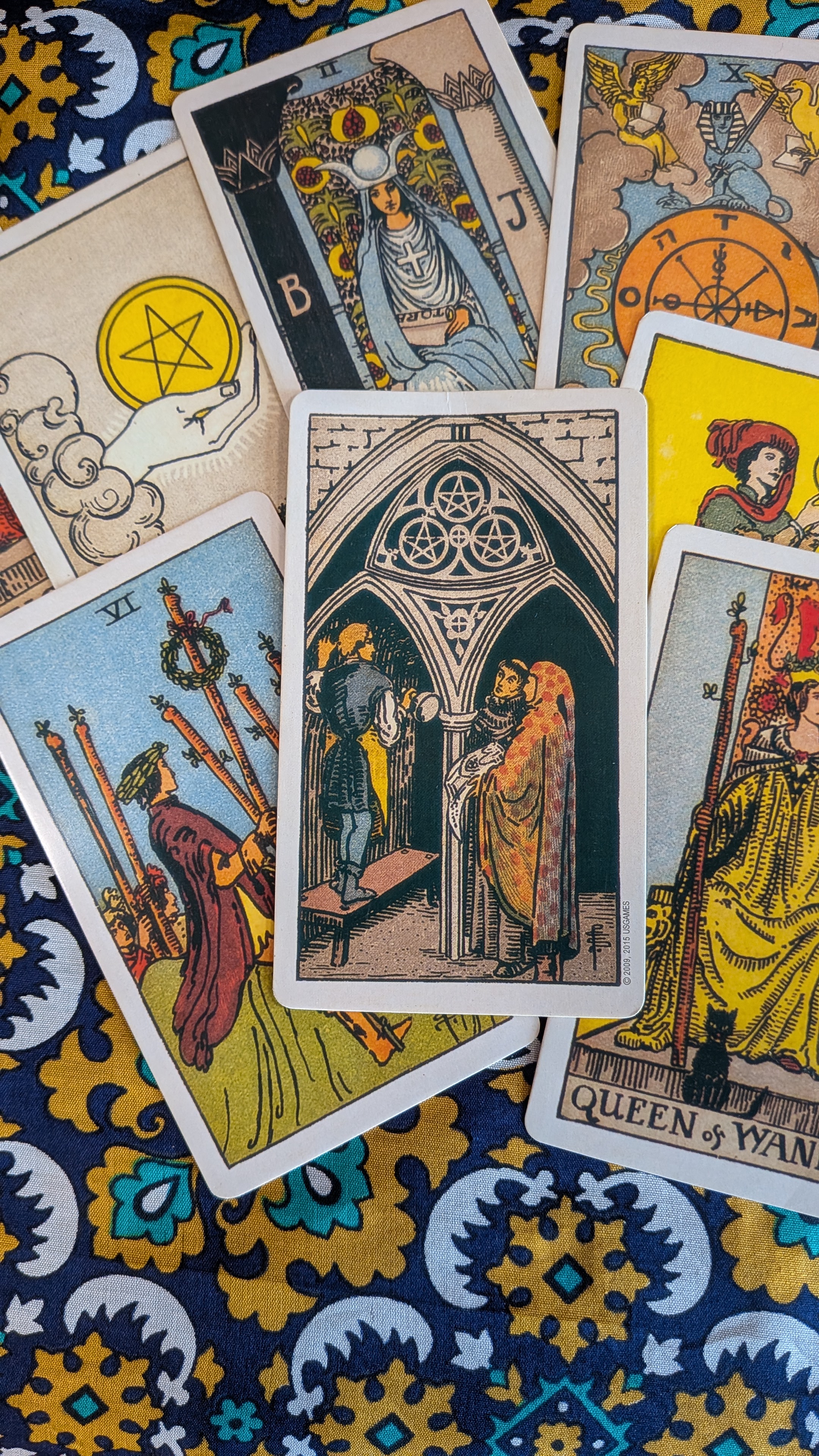 The Three of Pentacles taking centre stage in a spread of tarot cards.